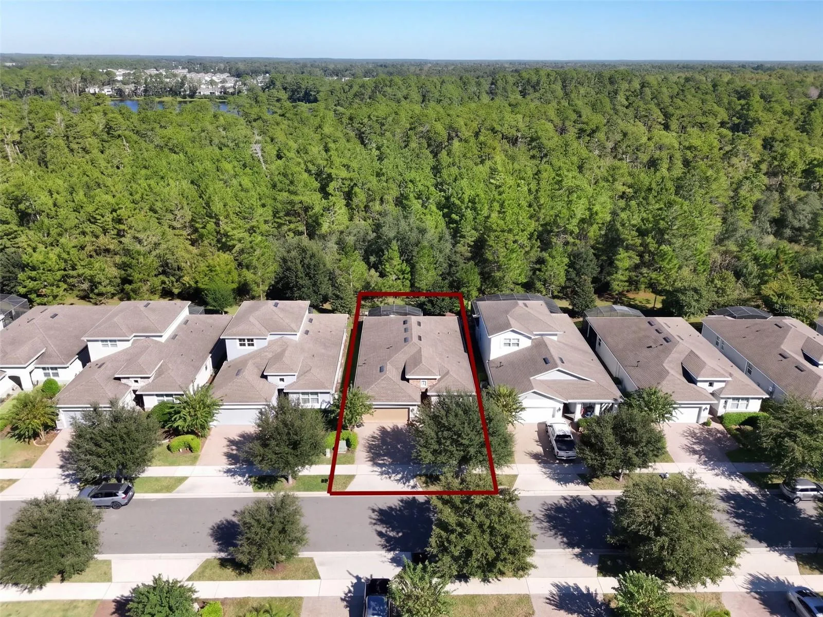 Aerial view of Home's location w/ a wooded view