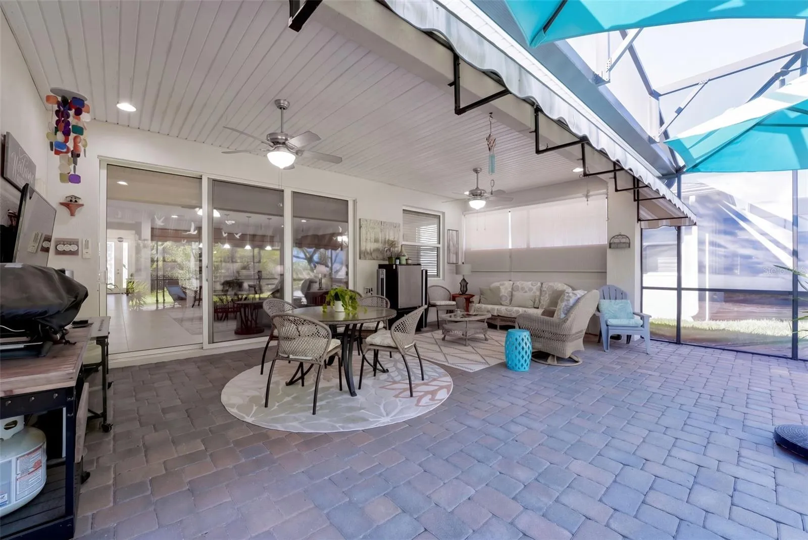 Screen enclosed covered Lanai w/ 2 ceiling fans, recessed lighting &amp; a wall mounted flat screen TV