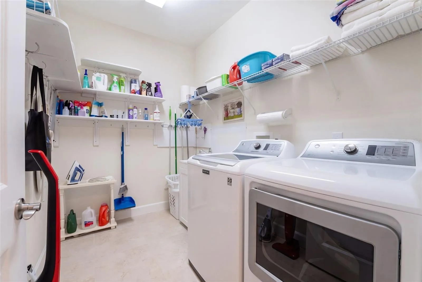 9' x 6'6" Utility Room w/ laundry tub, washer, natural gas dryer &amp; storage shelves
