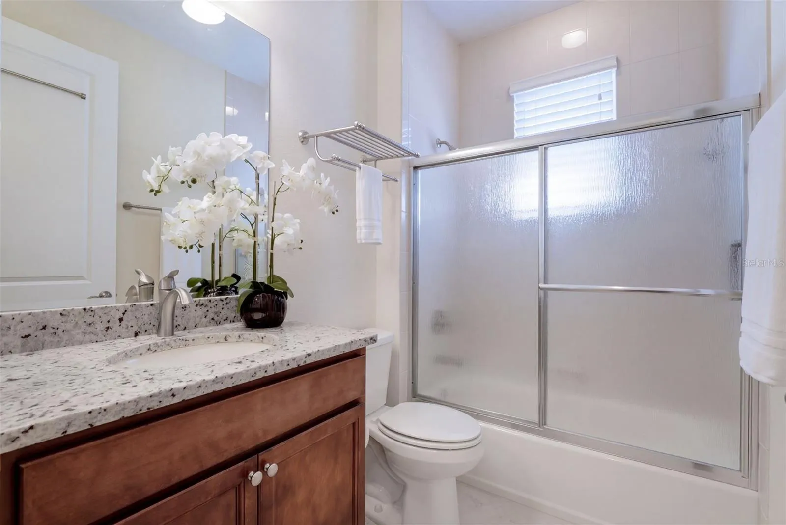 Guest Bathroom w/ granite countertop vanity &amp; Tub/Shower combo w/ sliding glass enclosure