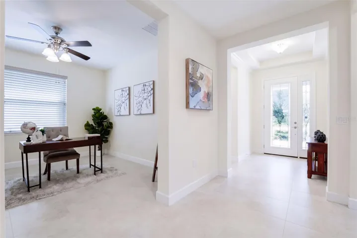 Foyer entryway w/ leaded glass door, sliding screen door, porcelain tile &amp; a tray ceiling