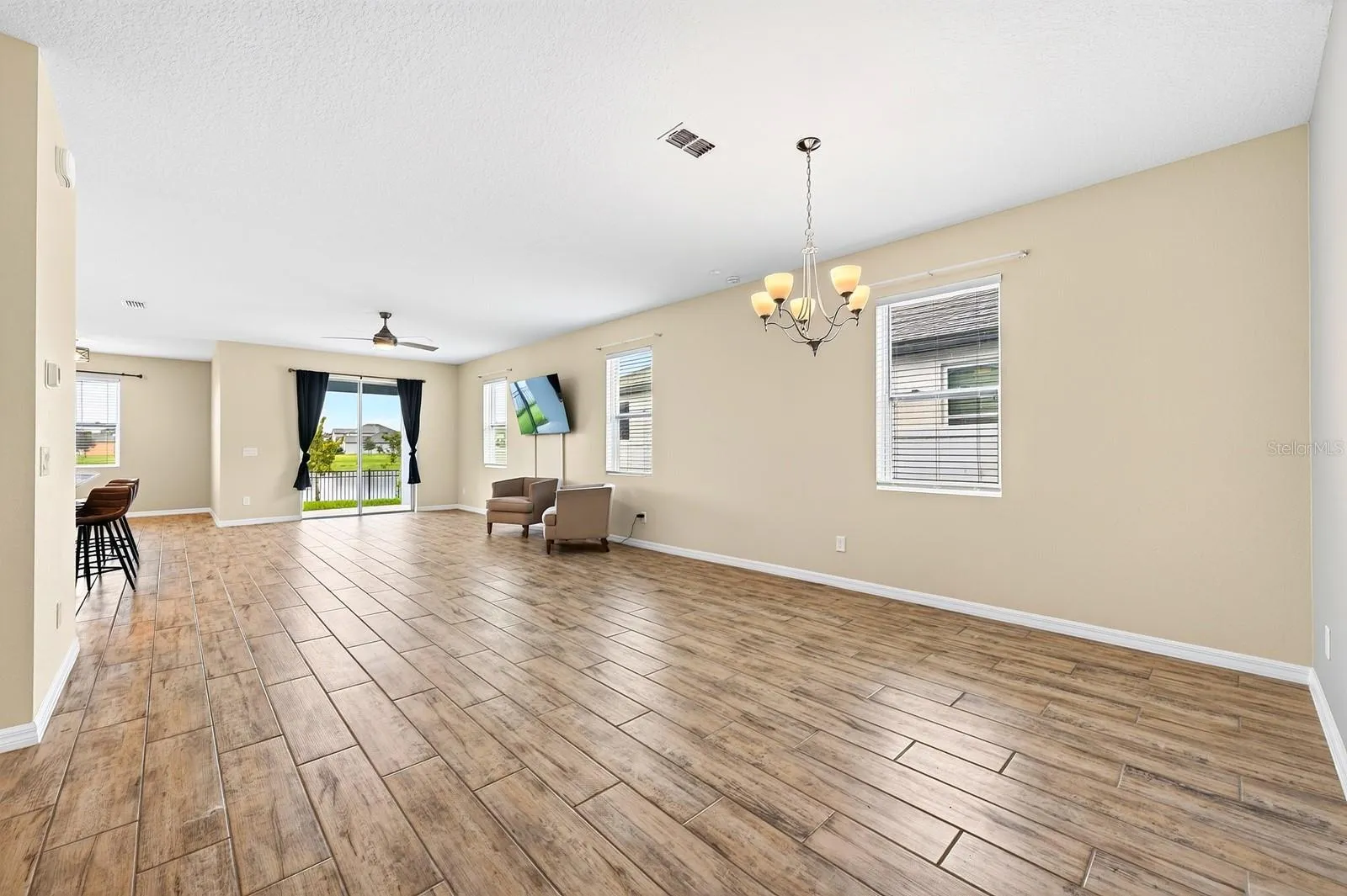 Welcome in to your new home! Look at that natural light and HUGE space with gorgeous porcelain wood-looking tile throughout!