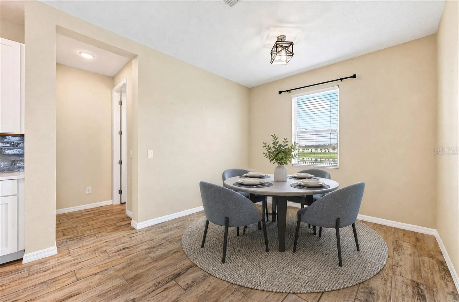 **Virtually Staged** Cozy breakfast nook with an updated light fixture