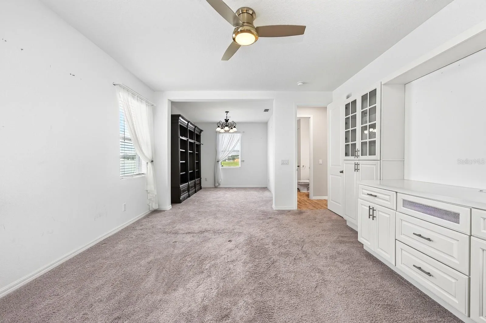 Check out those drawers under the TV (or artwork) space along with the natural light from the 2 windows