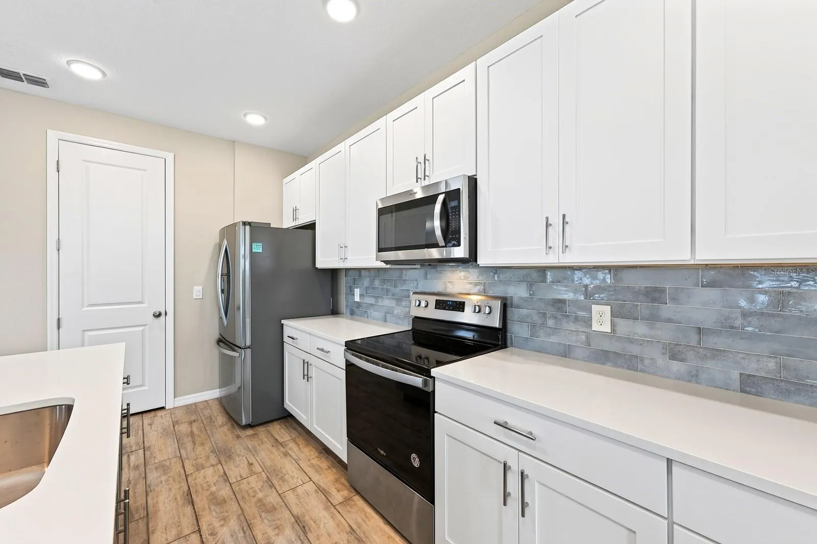 Beautiful WHITE cabinets and a greyish/blue subway tile backsplash