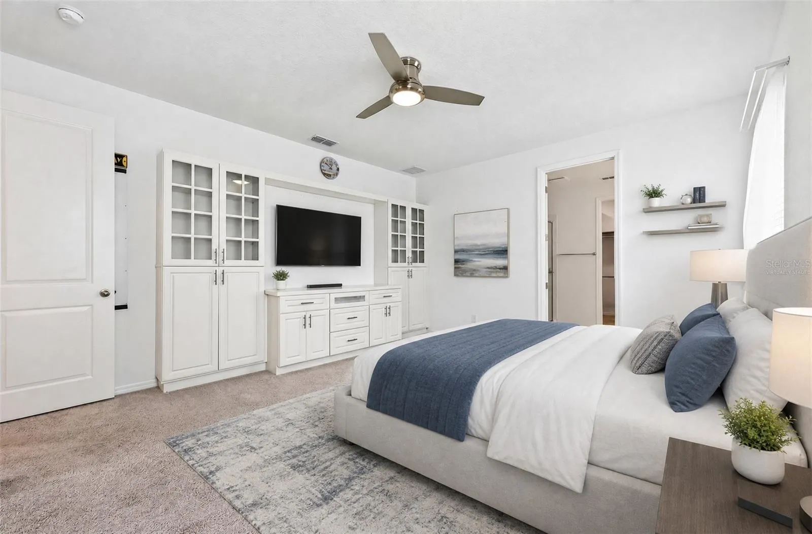 **Virtually Staged** Stunning primary suite with built-ins, carpet, and a ceiling fan
