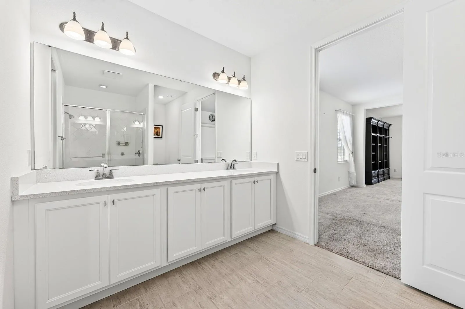 Wood-look neutral colored tile and lots of cabinet storage