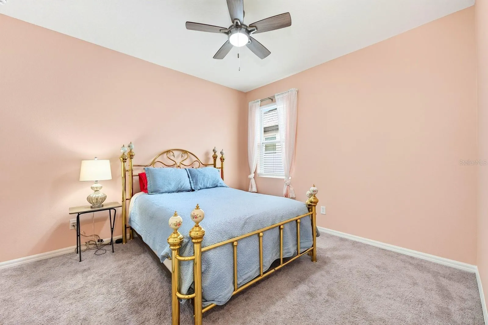 Perfect secondary bedroom with carpet and a ceiling fan