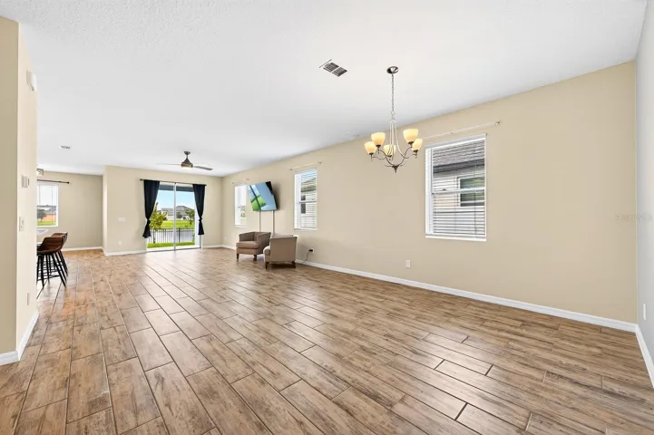 Welcome in to your new home! Look at that natural light and HUGE space with gorgeous porcelain wood-looking tile throughout!