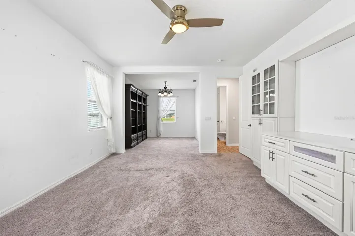 Check out those drawers under the TV (or artwork) space along with the natural light from the 2 windows