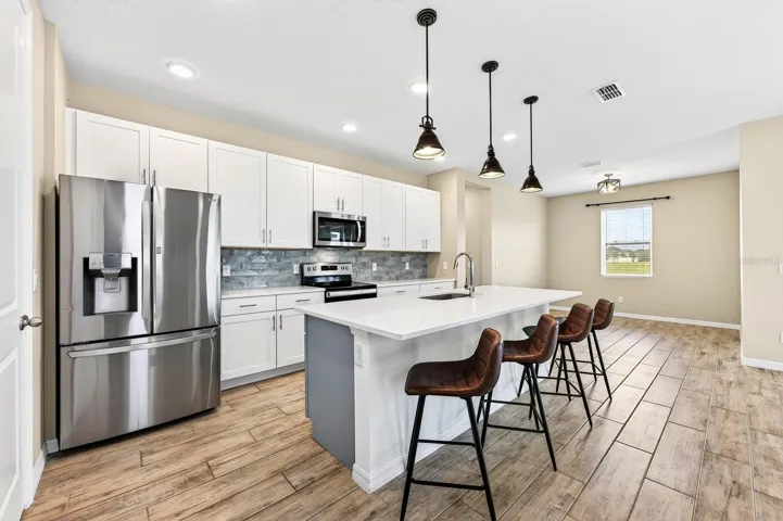 The oversized island provides extra space to serve, eat, and entertain