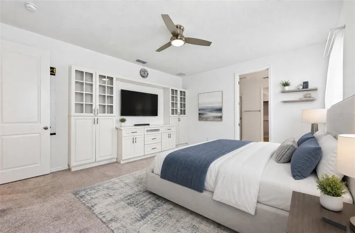 **Virtually Staged** Stunning primary suite with built-ins, carpet, and a ceiling fan