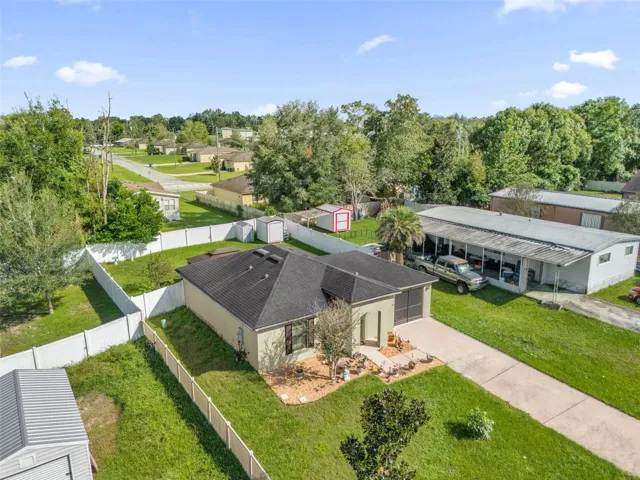 Aerial view of home and fenced backyard