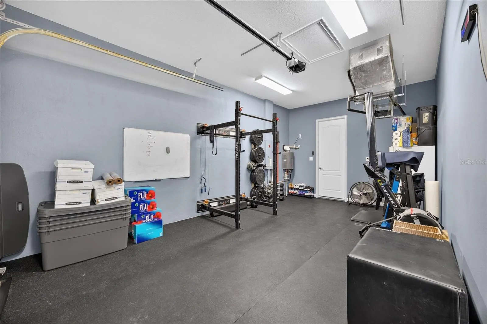 Gym equipment folds away for vehicle parking.