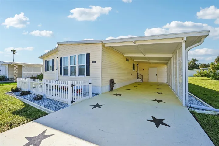 Long drive-way with covered carport and shed with laundry