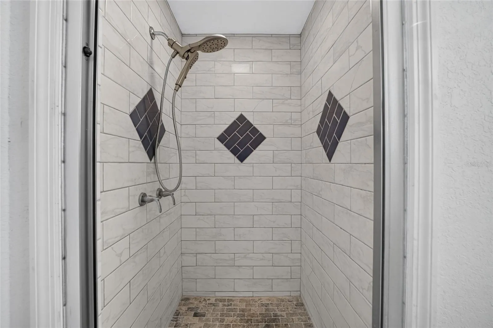 Premium tile and fixtures in the renovated walk in shower