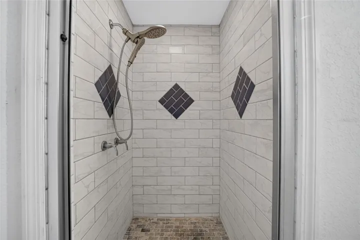 Premium tile and fixtures in the renovated walk in shower