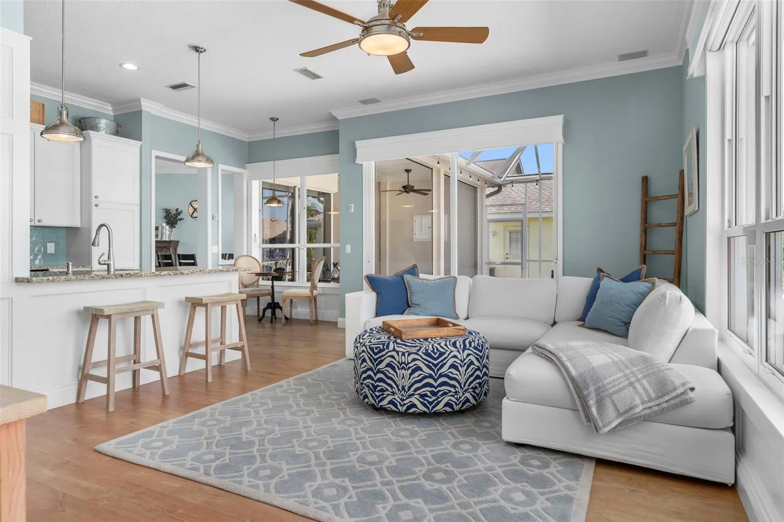 Sliding glass doors open to the covered lanai, extending this comfortable gathering space outdoors