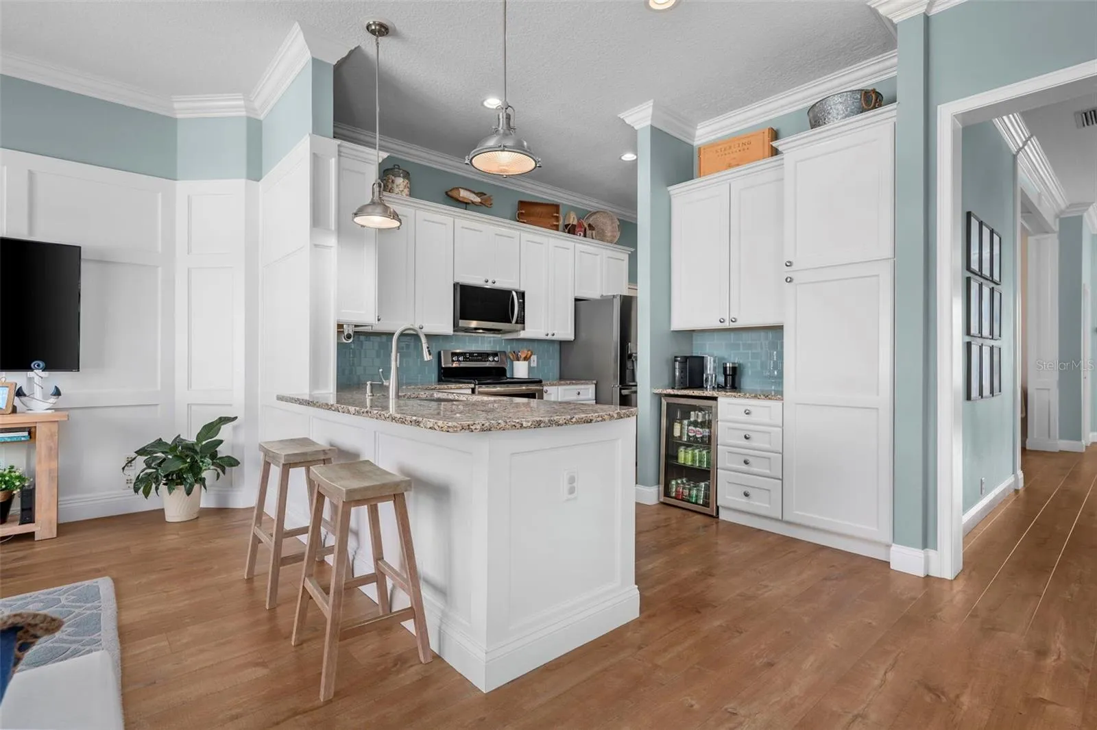 Tall cabinetry w/ built ins adds useful storage beside a cozy breakfast nook, with the dining room conveniently nearby.