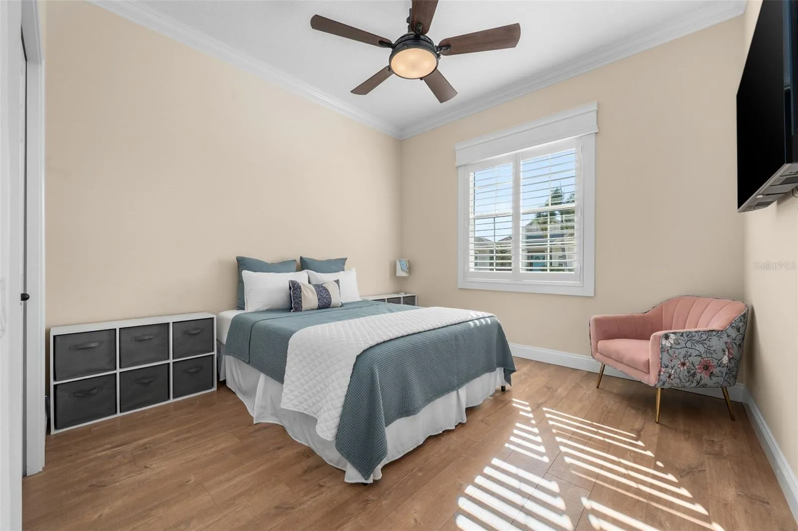 Sunlight filters through plantation shutters, creating a warm and inviting place for guests to unwind.