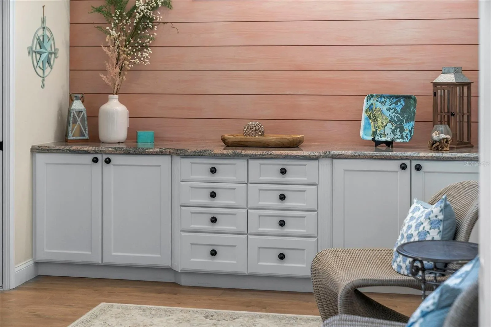 A shiplap accent wall and generous built-in cabinetry bring warmth and practical storage to this comfortable retreat.