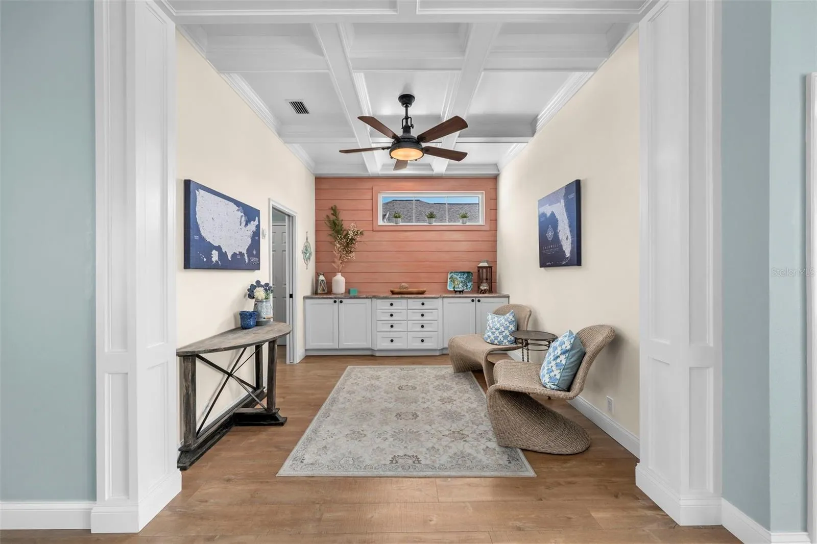 Coffered ceilings and custom built-ins give the den character and flexibility for work, reading, or relaxing.