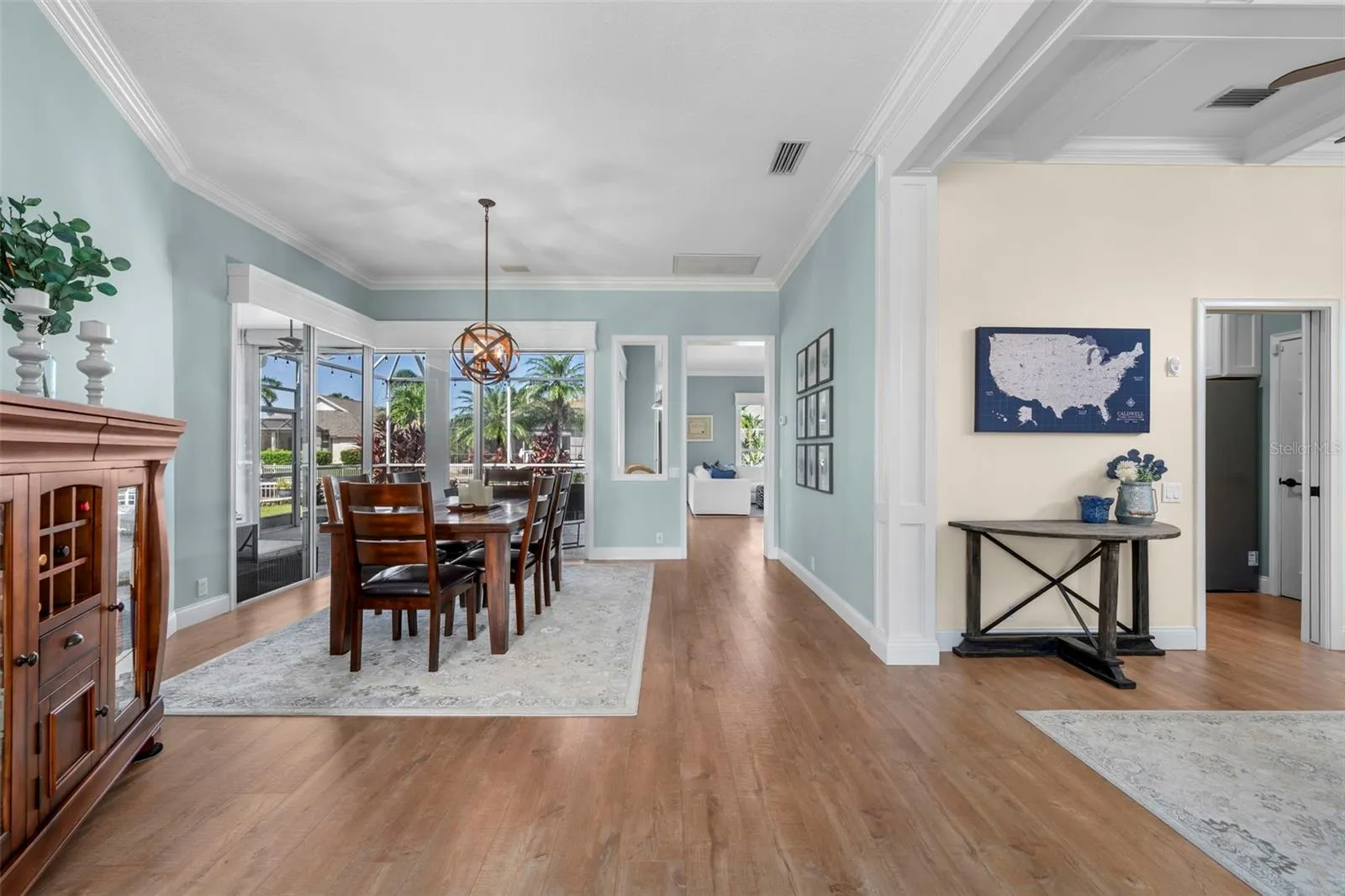 An open, inviting layout connects the dining area and den, with thoughtful architectural details throughout.