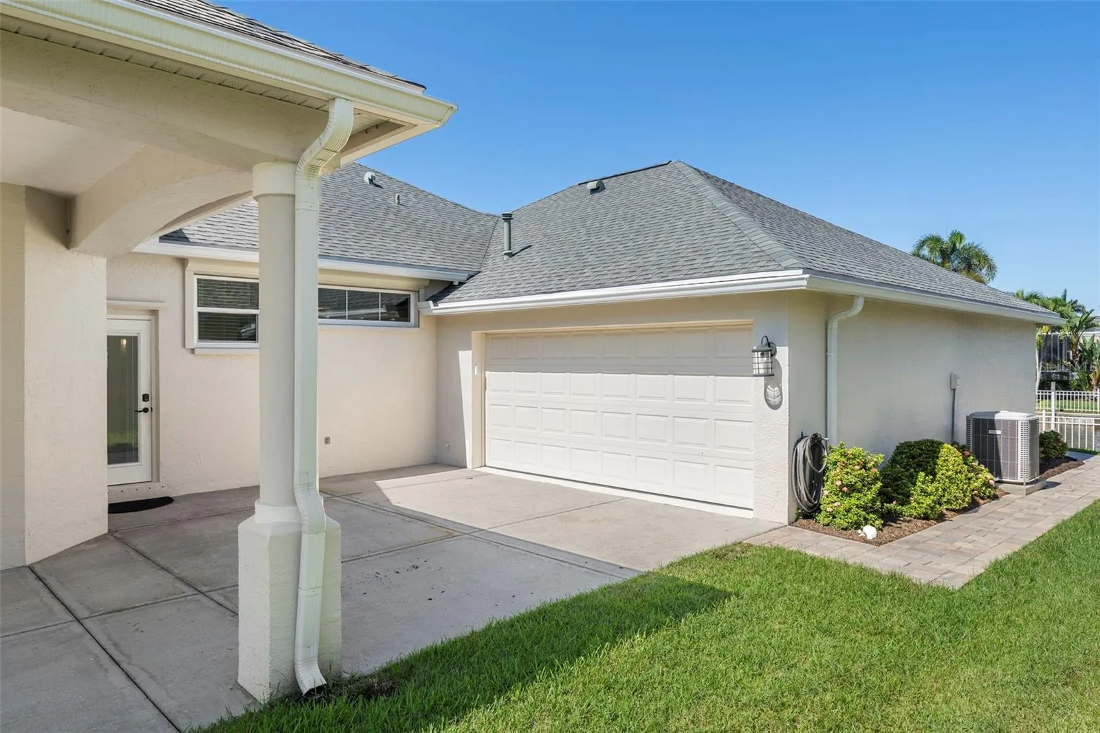 The spacious tandem garage features finished flooring and room for vehicles, a golf cart, storage, and boating essentials.