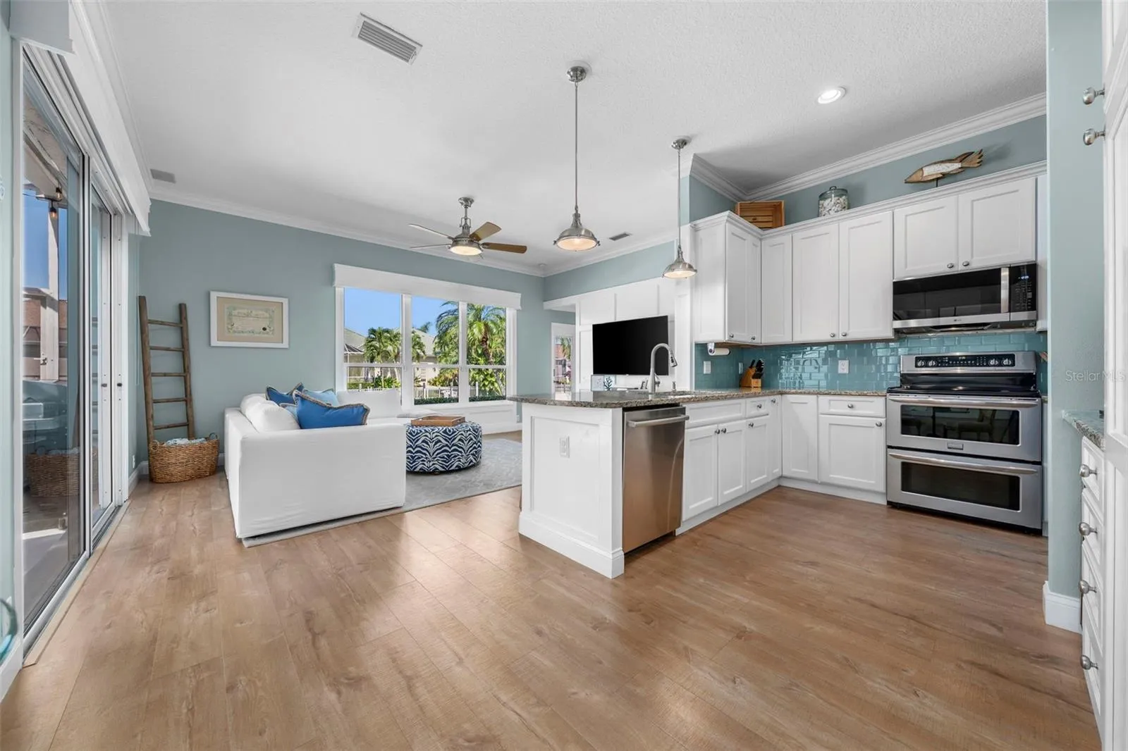 Granite countertops, custom maple cabinetry, and an open connection to the living area make everyday cooking and gathering with friends feel easy.