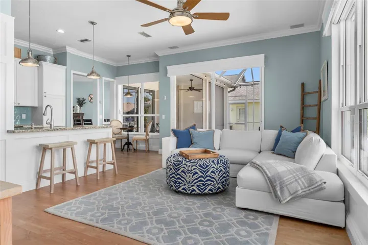 Sliding glass doors open to the covered lanai, extending this comfortable gathering space outdoors
