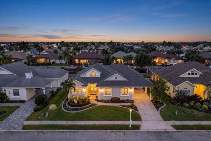 Welcome to 4739 Compass Drive—a beautifully renovated waterfront home with inviting curb appeal and tropical landscaping in The Inlets.
