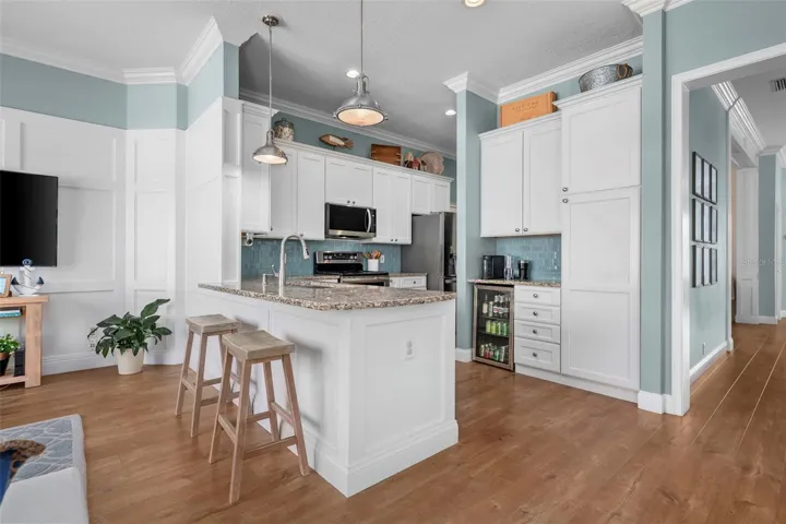 Tall cabinetry w/ built ins adds useful storage beside a cozy breakfast nook, with the dining room conveniently nearby.