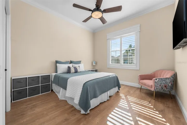 Sunlight filters through plantation shutters, creating a warm and inviting place for guests to unwind.