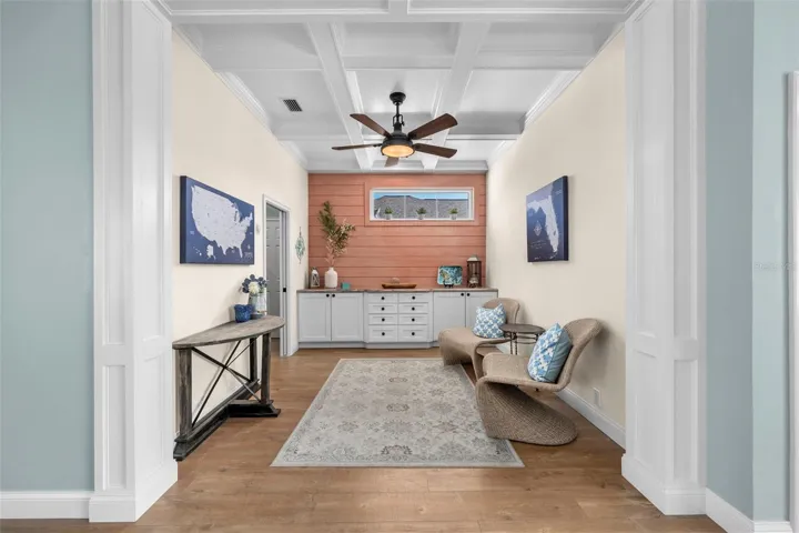 Coffered ceilings and custom built-ins give the den character and flexibility for work, reading, or relaxing.