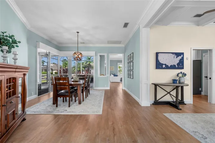 An open, inviting layout connects the dining area and den, with thoughtful architectural details throughout.
