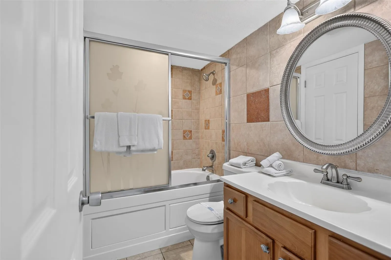 Bathroom features a spacious shower and a luxurious Jacuzzi soaking tub.
