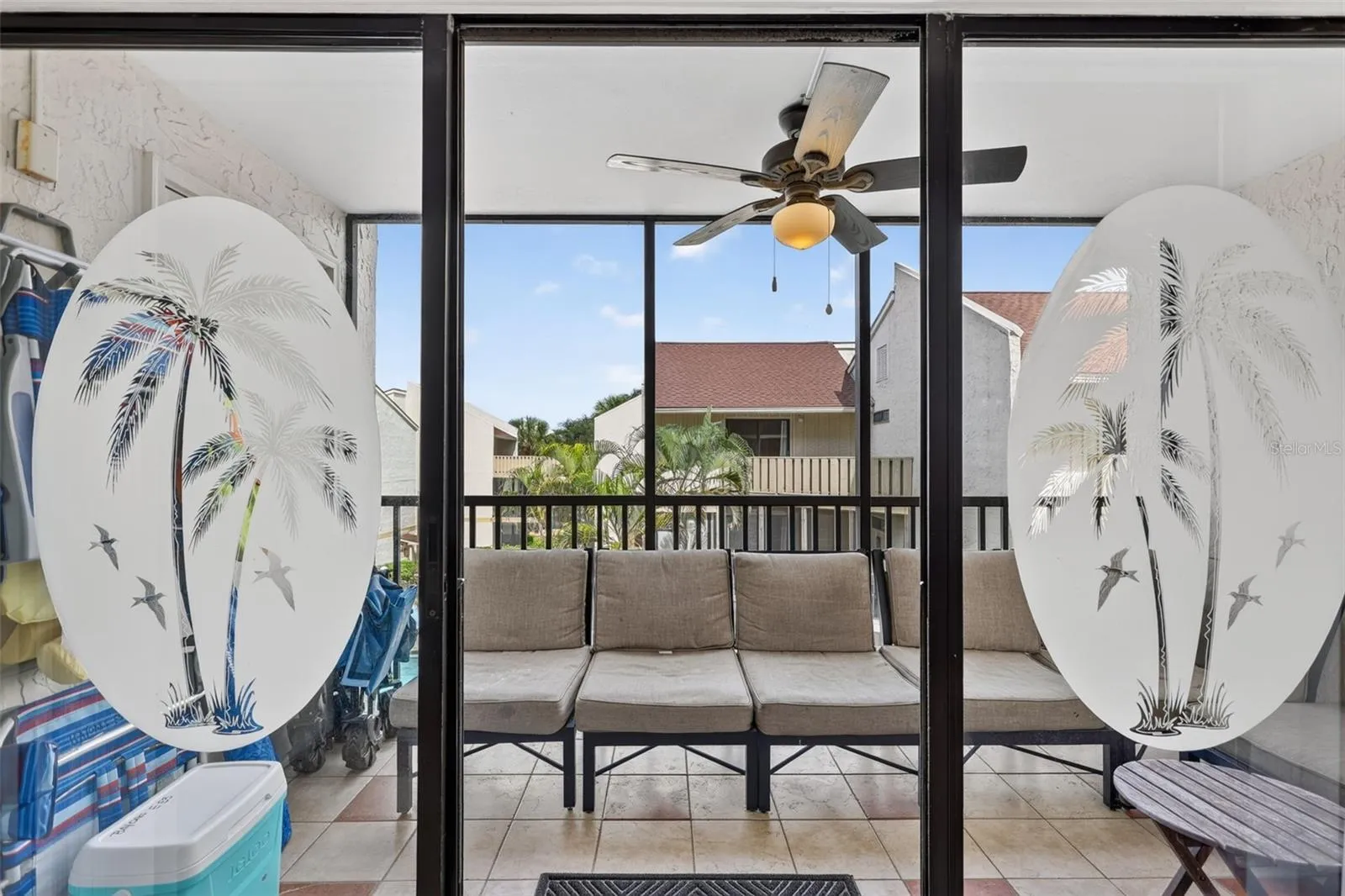 Sliding glass doors with etched detailing opening to a balcony with views overlooking the pool.