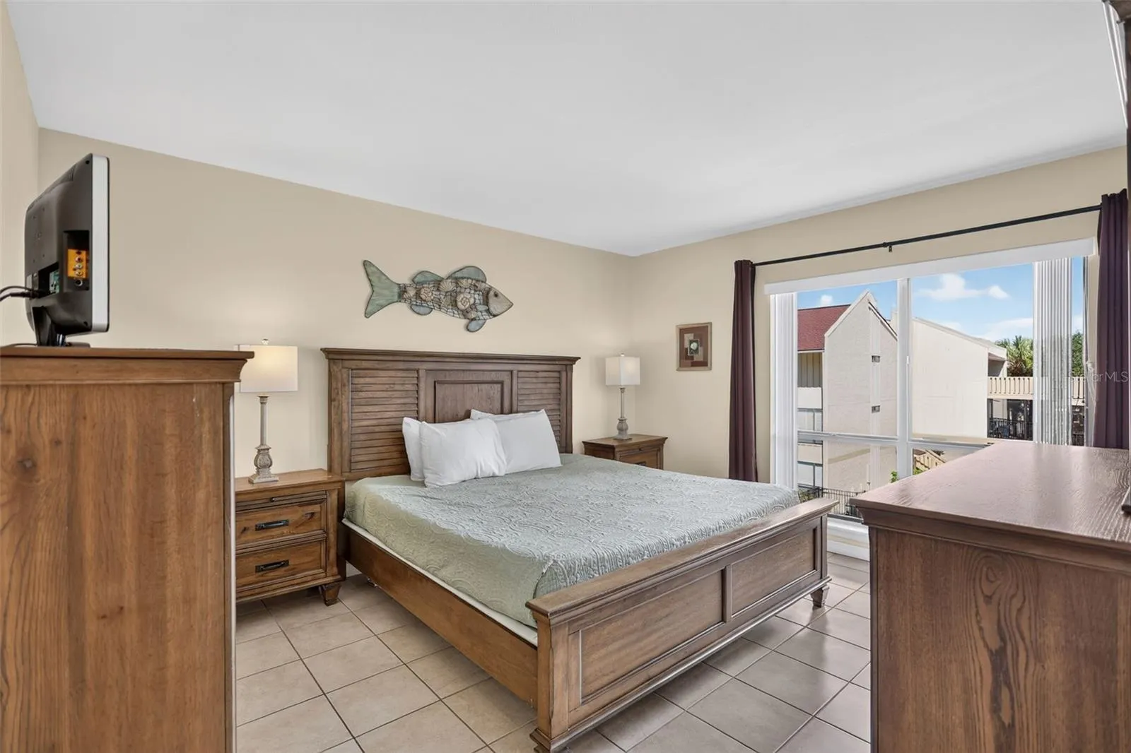 Spacious primary ensuite bedroom featuring a beautiful view of the pool.