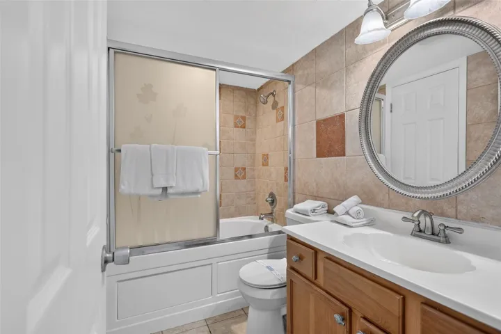 Bathroom features a spacious shower and a luxurious Jacuzzi soaking tub.