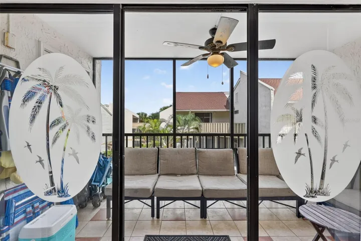 Sliding glass doors with etched detailing opening to a balcony with views overlooking the pool.