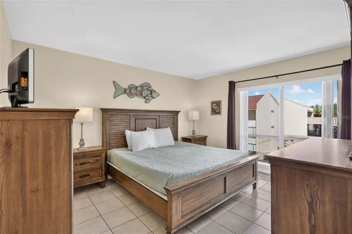 Spacious primary ensuite bedroom featuring a beautiful view of the pool.