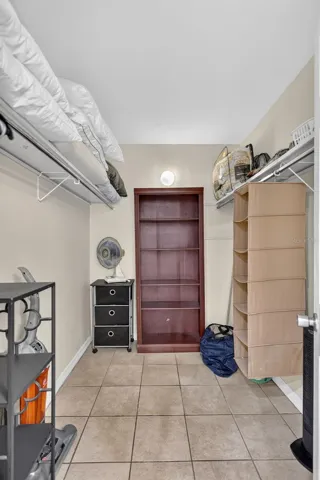 Walk-in closet with storage, located off the primary bathroom.