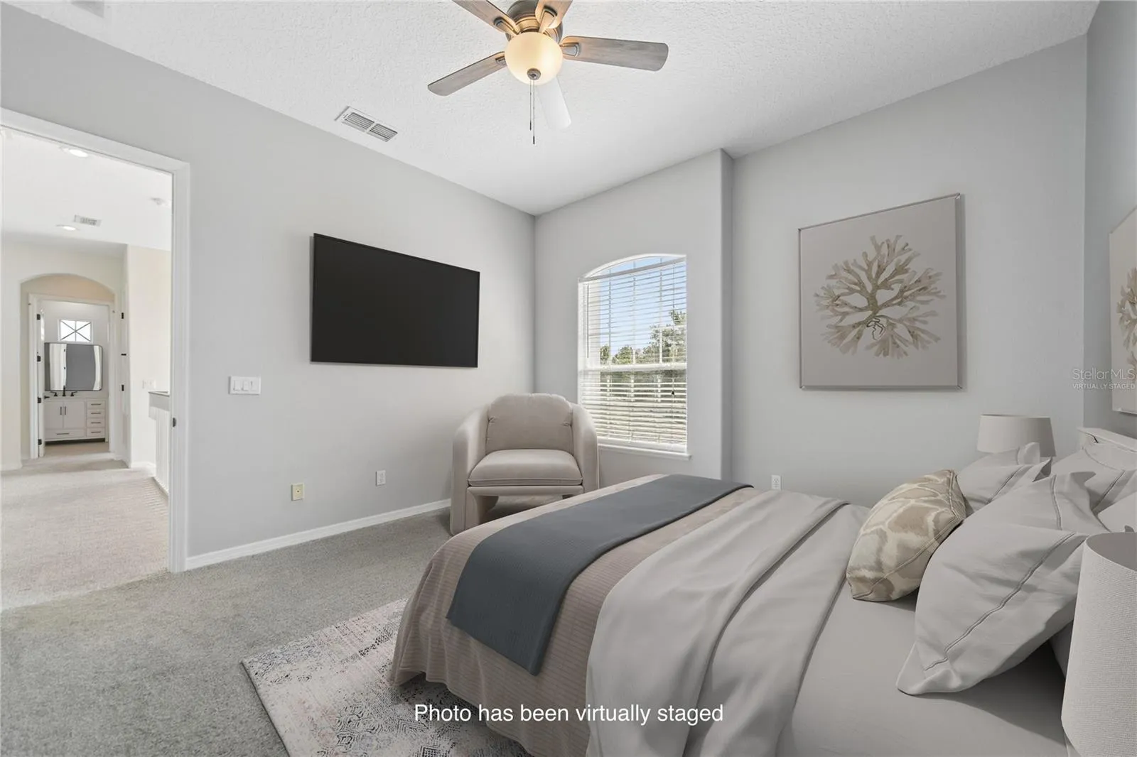 This is bedroom two with an ensuite and walk in closet for your guests or children to enjoy (photo virtually staged).