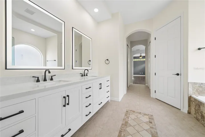 Walk past the two walk-in closets and into your primary bathroom with a water closet for your privacy.