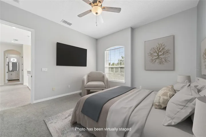 This is bedroom two with an ensuite and walk in closet for your guests or children to enjoy (photo virtually staged).