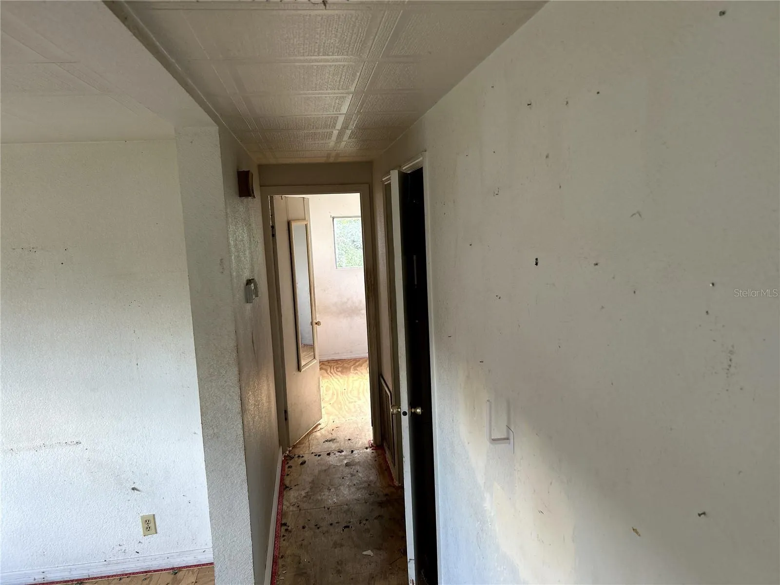 view down hall into primary bedroom