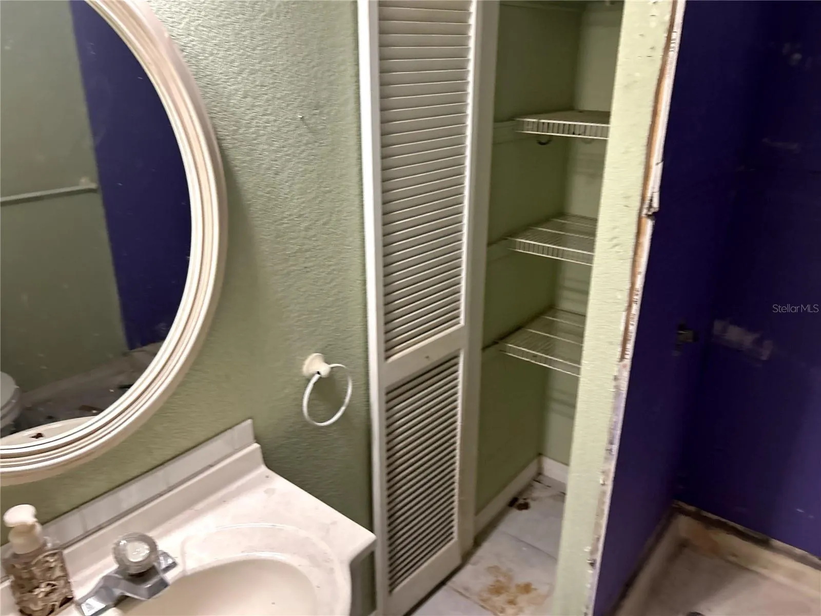 full bathroom with single vanity, linen closet, walk-in shower and toilet.