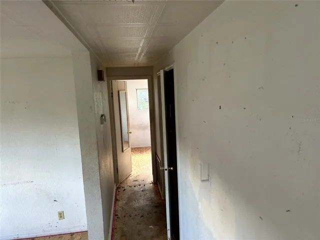 view down hall into primary bedroom
