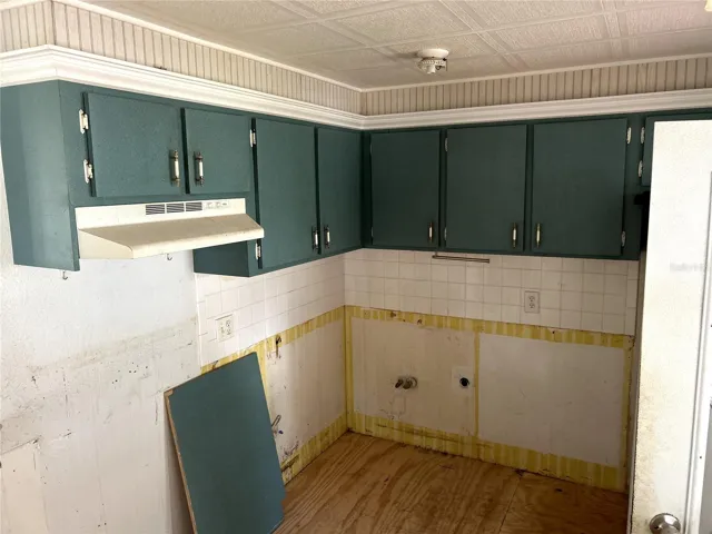 kitchen with working refrigerator and electric range.