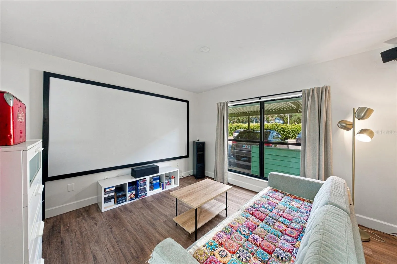 Second Bedroom used as a Movie Room with Plank Flooring and Large Closet